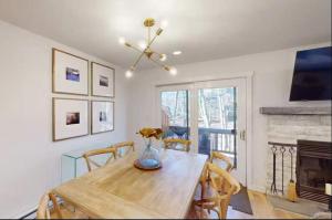 a dining room with a wooden table and a fireplace at 103 Ruffed Grouse Ct in Lake Harmony