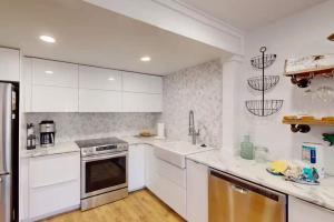 a kitchen with white cabinets and a stainless steel appliance at 103 Ruffed Grouse Ct in Lake Harmony +26 photos