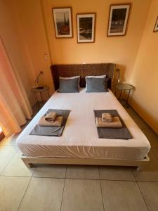 a bedroom with a large bed with towels on it at Thalassa Home A in Chiliadou