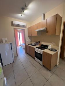 a kitchen with a stove and a refrigerator at Thalassa Home A in Chiliadou