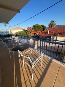 a group of chairs and a table on a balcony at Thalassa Home A in Chiliadou
