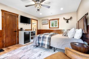 a bedroom with a bed and a flat screen tv at The Inn at the Rostay in Bethel +10 photos