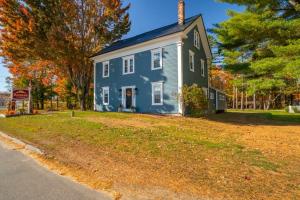 a blue house on the side of a street at The Inn at the Rostay in Bethel