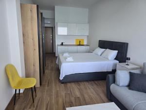 a bedroom with a large bed and a couch at Hotel Sutomore & Apartments in Sutomore