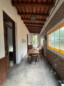 a dining room with a table and a brick wall at Casa Casona Las Toscas in Miramar