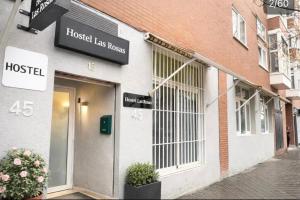 a store front of a building with a hostel at Hostel LAS ROSAS in Madrid