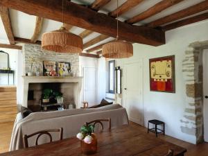 a living room with a bed and a table at La petite maison d'à côté in Noyers