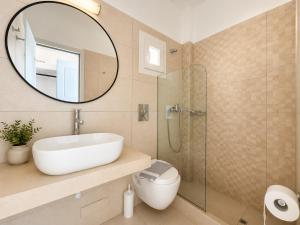a bathroom with a sink and a mirror at Eleftheria Hotel & Apartments in Ornos +39 photos
