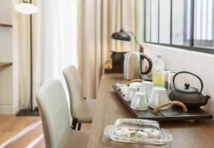 a table with a tray of food on it at The Residence Christokopidou Hotel & Spa in Athens