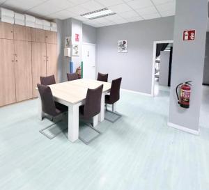 a conference room with a table and chairs at Hostel LAS ROSAS in Madrid