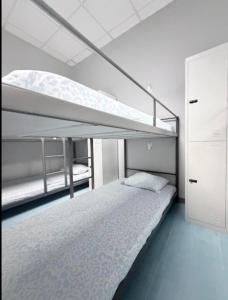 a bedroom with two bunk beds in a room at Hostel LAS ROSAS in Madrid