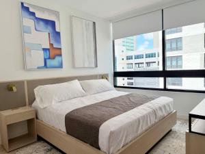 a bedroom with a bed and a large window at Chic Luxury 1BR Oasis in Miami +21 photos