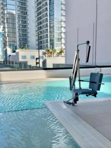 a chair sitting next to a swimming pool at Chic Luxury 1BR Oasis in Miami