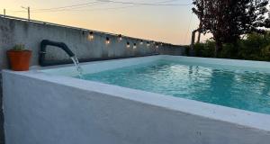 a swimming pool with a water fountain at Casa dos Avós in Campinho
