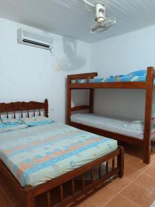 a bedroom with two bunk beds and a fan at Alojamiento Matuzalen in Coveñas