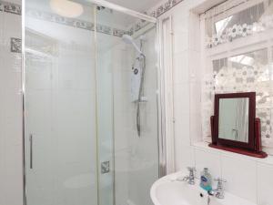 a bathroom with a shower and a sink at Agar Cottage in Port Isaac +27 photos