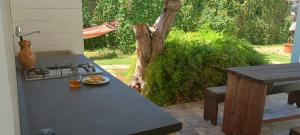 a table with a stove and a plate of food on it at Chalet Gallipoli in Gallipoli