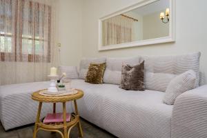 a living room with a couch with pillows and a table at Agia Paraskevi Villa Olive in Makri