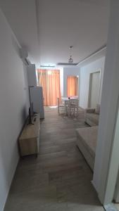 a living room with a couch and a table at Solei Sea Apartment in Shëngjin +3 photos
