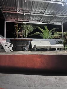 a bench sitting on a patio with plants at D,lacoco in Kubupenlokan