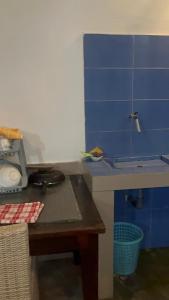 a toy kitchen with blue walls and a table at D,lacoco in Kubupenlokan