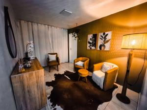 a living room with a couch and chairs and a table at Hotel El-Shaday in Vila Nova do Sul