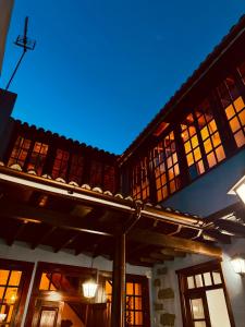 a building with windows and a roof at night at Coliving Tenerife - Villa La Laguna in Las Lagunas