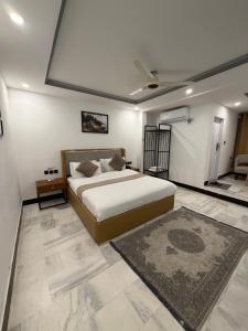 a bedroom with a large bed and a rug at Prestige by Alnoor in Skardu