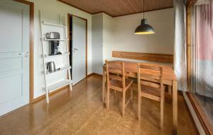 a dining room with a wooden table and chairs at Degeberga Stugby in Degeberga