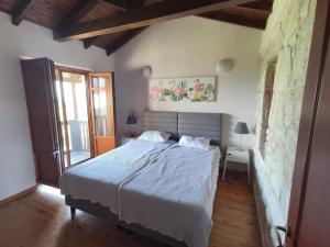 a bedroom with a bed with a white comforter at Villas garden&pool in Afitos +57 photos