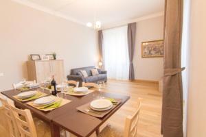 a dining room with a table and a couch at Cittadella 5 in Florence