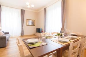 a dining room with a table and chairs and a couch at Cittadella 5 in Florence