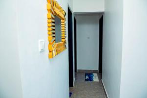a hallway with yellow and white dividers on the wall at AJHOMESKisumu in Kisumu