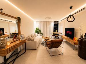 a living room with a couch and a tv at amor premium residence-4BR apartment with balcony in Beer Sheva