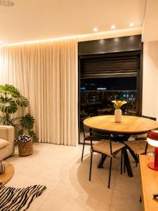 a living room with a table and a couch at amor premium residence-4BR apartment with balcony in Beer Sheva