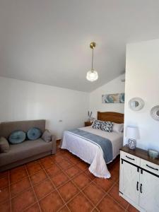a bedroom with a bed and a couch at Aldeana Rural in El Cubillo +34 photos