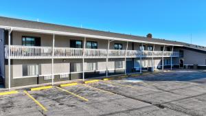a building with a parking lot in front of it at Super 8 by Wyndham Sturgis in Sturgis