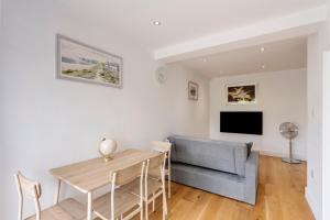 a living room with a table and a couch at Sunnymede Court in Billericay