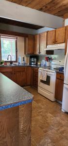 a kitchen with wooden cabinets and a white stove top oven at Brown Family Farm in Grand Forks