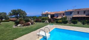 a house with a swimming pool in a yard at Villas garden&pool in Afitos