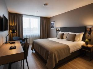 a hotel room with a bed and a desk at KM Rentals - Lillestrøm City Centre - Selected Hotels in Lillestrøm +5 photos