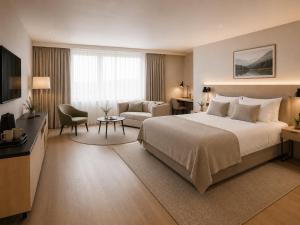 a hotel room with a large bed and a couch at KM Rentals - Lillestrøm City Centre - Selected Hotels in Lillestrøm