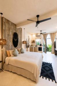 a bedroom with a large bed and a kitchen at Maison de Reve - Boutique Guest House in Brisas de Zicatela