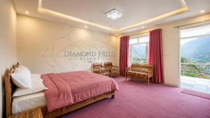 a bedroom with a bed with a sign on the wall at Diamond Hills Resort in Battakundi