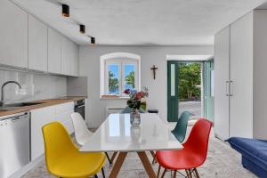 a kitchen with a white table and four chairs at Holiday Home Pelegrin in Brela +20 photos