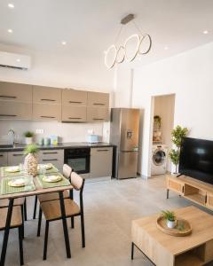 a kitchen and living room with a table and chairs at Celivine Seaside Residence in Faliraki