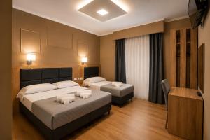 a hotel room with two beds and a television at EURHOTEL in Florence
