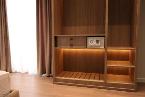 a cabinet with a microwave in it in a room at Olivia Hotel in Durrës