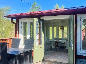 a pavilion with a table and chairs on a deck at 5 person holiday home in Häradsbäck in Ryd