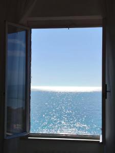 a window with a view of the ocean at Castello Di Marà in Cupra Marittima +23 photos